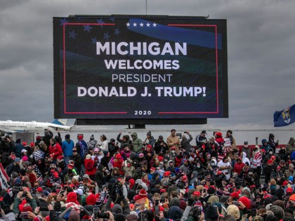 WATERFORD, MICHIGAN - OCTOBER 30: Supporters of U.S. President Donald Trump cheer as Air Force One arrives to a campaign rally at Oakland County International Airport on October 30, 2020 in Waterford, Michigan. With less than a week until Election Day, Trump and his opponent, Democratic presidential nominee Joe Biden, …