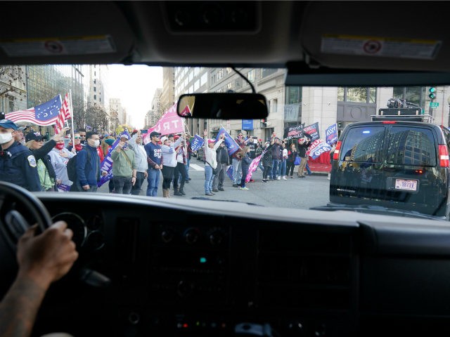 The motorcade of US President Donald Trump drives past supporters holding a rally in Washington, DC, on November 14, 2020. - Supporters are backing Trump's claim that the November 3 election was fraudulent. (Photo by MANDEL NGAN / AFP) (Photo by MANDEL NGAN/AFP via Getty Images)