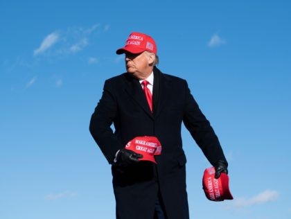 Trump tosses hats (Brendan Smialowski / AFP / Getty)