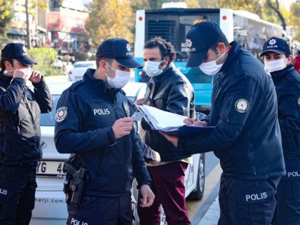 Police patrol a street in Ankara on November 13, 2020, after Turkey banned smoking in outd