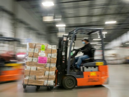 Mail handler Jimmy Tran unloads pallets filled with Washington and Oregon mail-in ballots at a U.S. Postal Service (USPS) processing and distribution center on October 14, 2020 in Portland, Oregon. USPS workers in Portland began processing and mailing about 1.5 million ballots this week ahead of the November election. (Photo …