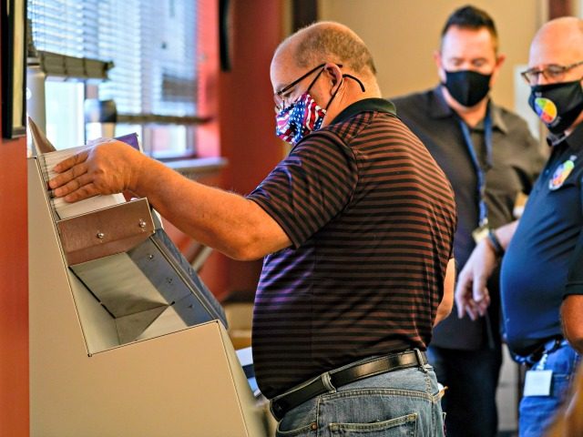 Municipal workers use a machine to open Luzerne County ballots, Wednesday, Nov. 4, 2020, in Wilkes-Barre, Pa. (AP Photo/Mary Altaffer)