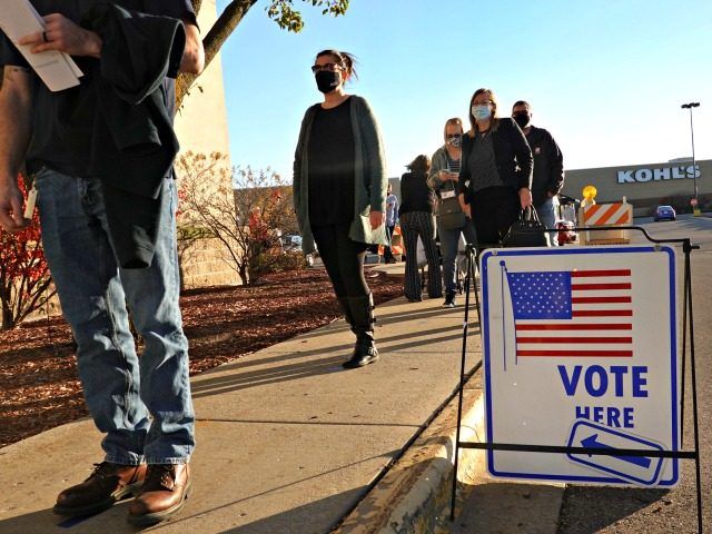 JANESVILLE, WISCONSIN - NOVEMBER 03: Residents wait in line to vote at a shuttered Sears s