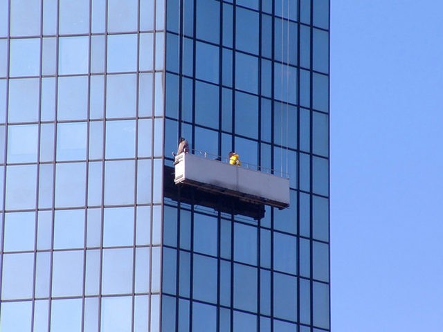 Window cleaner at a skyscraper facade