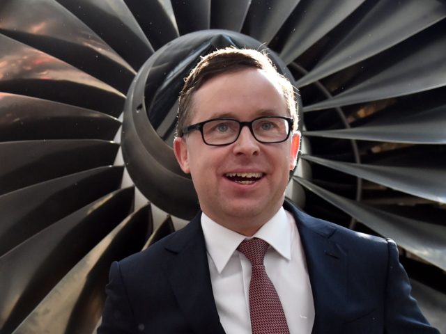 CORRECTION Qantas chief executive Alan Joyce poses for photos after a press conference in Sydney on August 20, 2015. Australia carrier Qantas roared back into the black in a stunning turnaround of fortunes driven by aggressive cost-cutting, while placing an order for eight Boeing Dreamliners. AFP PHOTO / SAEED KHAN …