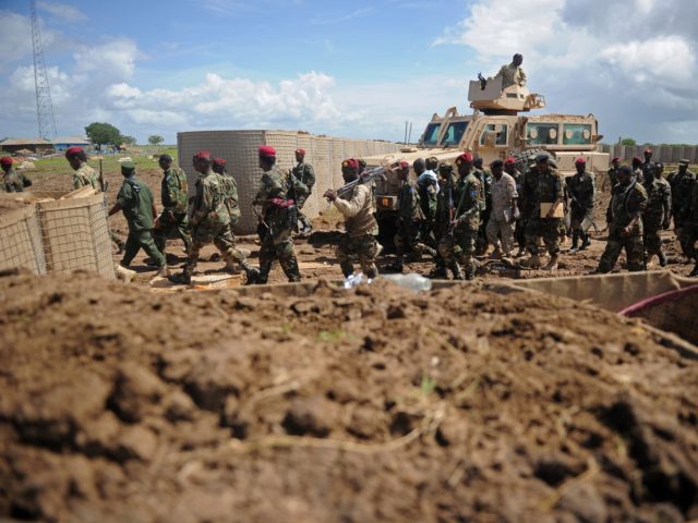 Somali soldiers enter Sanguuni military base, where an American special operations soldier