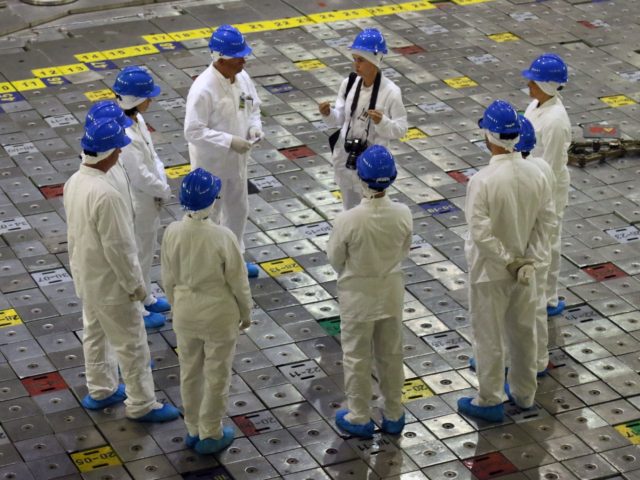 People take part in a guided tour inside the inoperative Ignalina nuclear power plant in Visaginas, Lithuania, on July 31, 2019. - Fans of HBO's hit series "Chernobyl", detailing the world's worst nuclear disaster, can get a behind-the-scenes glimpse at the Emmy-nominated TV drama by taking a new tour of …