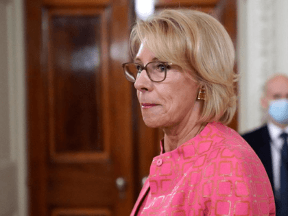 In this Aug. 12, 2020, file photo Education Secretary Betsy DeVos arrives for an event in the State Dining room of the White House in Washington. As millions of American children start the school year online, the Trump administration is hoping to convert their parents’ frustration and anger into newfound …