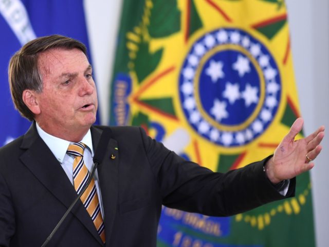 Brazilian President Jair Bolsonaro gestures as he speaks during the launch of a program fo