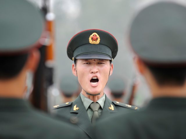 A military officer (C) shouts an order to soldiers of the Guards of Honour of the Three Services of the Chinese People's Liberation Army (PLA) during a training session at a barracks in Beijing on July 21, 2011. The honour guard troops were established in March 1952 and is the …