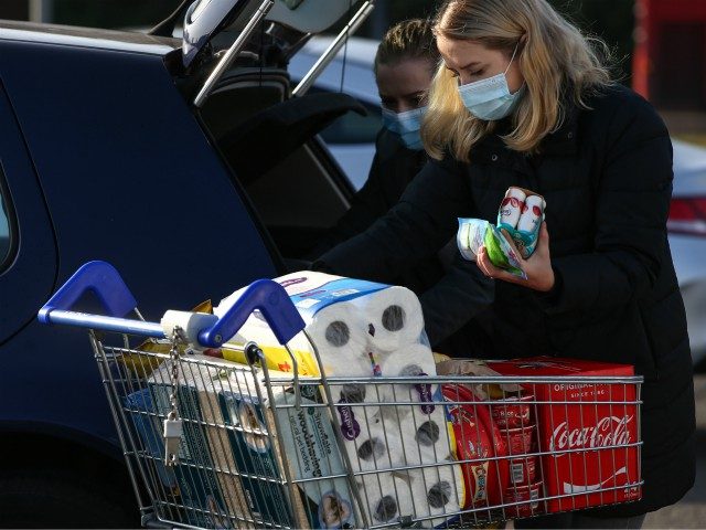 LONDON, ENGLAND - NOVEMBER 07: Shoppers load groceries into their car outside a Tesco Extr