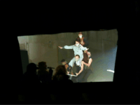 Covid Culture: Circus Act Performs on a Stage Behind a Window