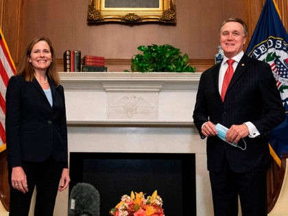 Judge Amy Coney Barrett, President Donald Trumps nominee for Supreme Court, stands for a photo with Senator David Perdue, R-GA at the US Capitol on September 30, 2020, in Washington, DC. (Photo by Manny CENETA / POOL / AFP) (Photo by MANNY CENETA/POOL/AFP via Getty Images)
