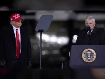 President Donald Trump listens as Franklin Graham prays at a campaign rally on Sunday, Nov. 1, 2020, at Hickory Regional Airport in Hickory, N.C. (AP Photo/Chris Carlson)