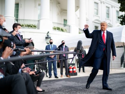 President Donald J. Trump gives a fist bump to the press Friday, Oct. 30, 2020, prior to boarding Marine One en route to Joint Base Andrews, Md. to begin his trip to Michigan, Wisconsin and Minnesota. (Official White House Photo by Tia Dufour)