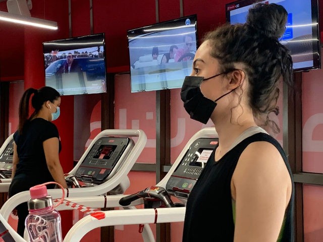 A woman, wearing a protective face mask, trains at a gym in Saudi Arabia's capital Riyadh on June 23, 2020, as the country begins to re-open following the lifting of a lockdown due to the COVID-19 coronavirus pandemic. (Photo by RANIA SANJAR / AFP) (Photo by RANIA SANJAR/AFP via Getty …