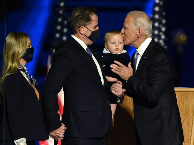 US President-elect Joe Biden (R) kisses his grandson held by son Hunter Biden after he and Vice President-elect Kamala Harris delivered remarks in Wilmington, Delaware, on November 7, 2020, after being declared the winners of the presidential election. (Photo by Jim WATSON / AFP) (Photo by JIM WATSON/AFP via Getty …