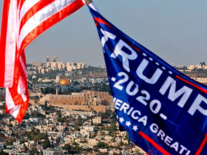 This picture taken on October 27, 2020 shows a view of US and Trump campaign flags flying in Jerusalem with the background showing the Dome of the Rock (C) within the Aqsa mosque, or Temple Mount, complex holy to both Muslims and Jews. (Photo by Emmanuel DUNAND / AFP) (Photo …