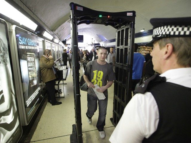 LONDON, ENGLAND - JUNE 02: Police watch as a youth walks through a knife-arch security sca