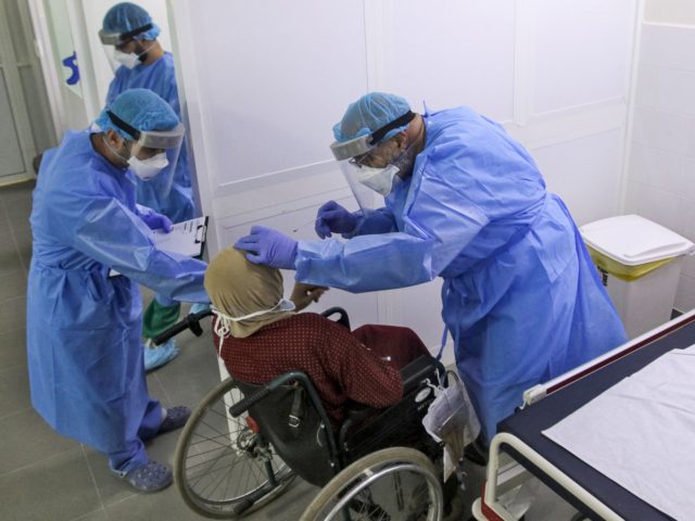 A doctor tests a woman at a hospital, as part of a mobile clinic initiative by LAU (Lebanese American University) School of Medicine and LAU Medical Center-Rizk Hospital to provide medical services to remote areas, in the southern Lebanese city of Nabatieh on April 4, 2020. (Photo by Mahmoud ZAYYAT …