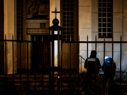 Police officers examine the entrance of the Orthodox Church where …