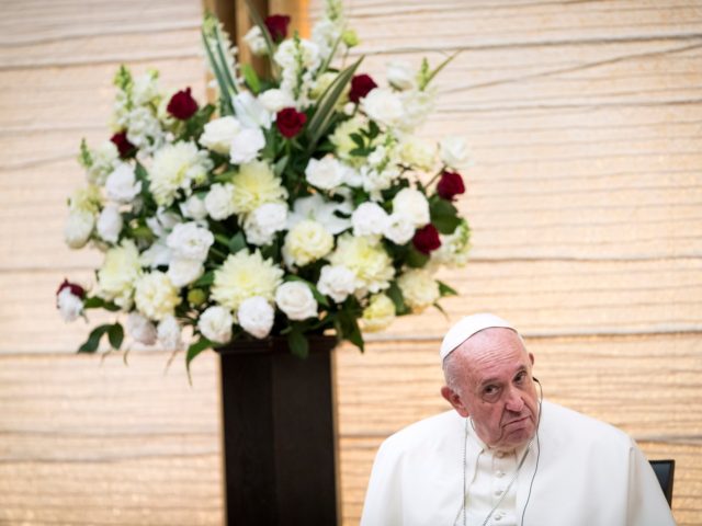 Pope Francis listens to the speech of Japan's Prime Minister Shinzo Abe as they attend a meeting with the diplomatic community at the prime minister's office in Tokyo on November 25, 2019. - Pope Francis called on November 25 for renewed efforts to help victims of Japan's 2011 "triple disaster" …
