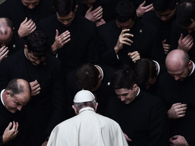 TOPSHOT - Pope Francis prays with priests at the end of a limited public audience at the S