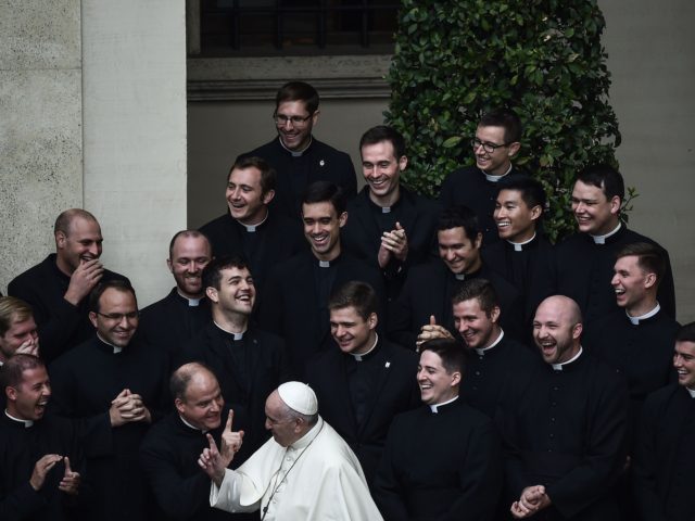 TOPSHOT - Pope Francis jokes with priests at the end of a limited public audience at the S