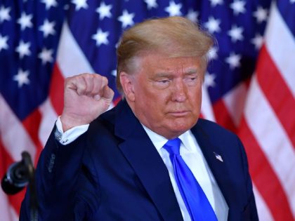 US President Donald Trump pumps his fist after speaking during election night in the East