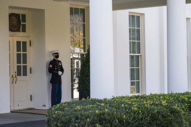 A Marine is posted outside the West Wing of the White House, signifying the President is in the Oval Office, Thursday, Nov. 5, 2020, in Washington. (AP Photo/Evan Vucci)