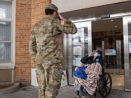U.S. Army Staff Sgt. Jonathan Pietrantoni, assigned to the 53rd Troop Command, New York Army National Guard, salutes World War II veteran Pfc. Joseph Casaburi on his 99th birthday after he survived a three-month long battle with COVID-19 at the nursing home Angus on Hudson, Hastings-on-Hudson, N.Y., on Dec. 8, …