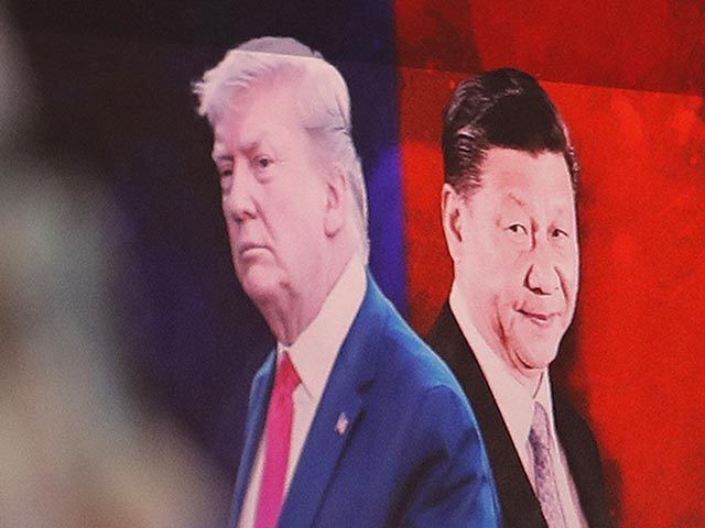 FIEL - In this Aug. 26, 2019, file photo, a computer screen shows images of Chinese President Xi Jinping, right, and U.S. President Donald Trump as a currency trader works at the foreign exchange dealing room of the KEB Hana Bank headquarters in Seoul, South Korea. China will lift punitive …