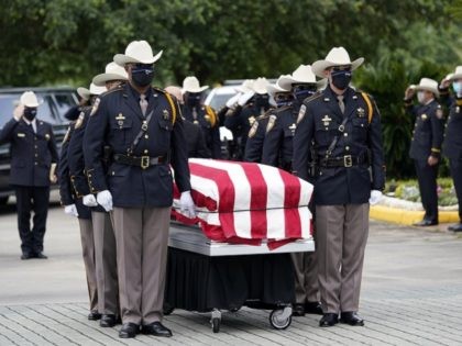 Members of the Harris County Sheriff's Honor Guard move the casket of Sgt. Raymond Scholwinski during a funeral service Thursday, May 14, 2020, in Humble, Texas. Sgt. Scholwinski died last week after contracting COVID-19. (AP Photo/David J. Phillip)