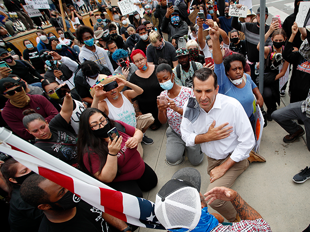 Mayor Sam Liccardo takes a knee with group of protesters in San Jose, Calif., Sunday, May