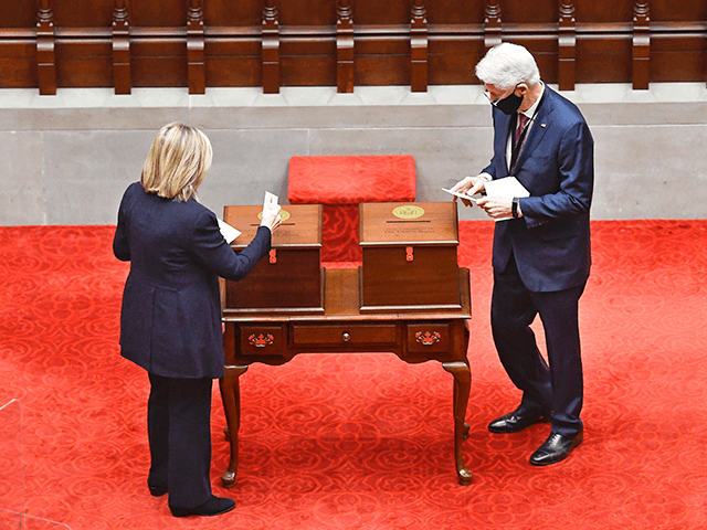 New York Electoral College members, Former Sec. of State Hillary Clinton, left, and Former President Bill Clinton, vote for President and Vice President in the Assembly Chamber at the state Capitol in Albany, N.Y., Monday, Dec. 14, 2020. (AP Photo/Hans Pennink, Pool)