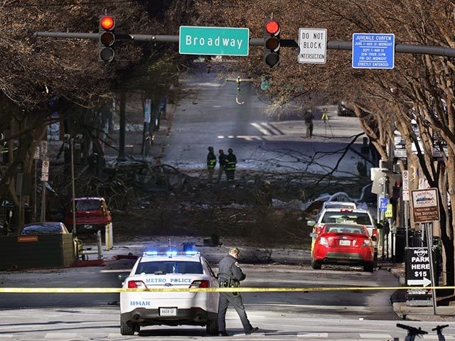 A Nashville Police officer blocks the entrance to the scene of an explosion Saturday, Dec. 26, 2020, in Nashville, Tenn. The explosion that shook the largely deserted streets of downtown Nashville early Christmas morning shattered windows, damaged buildings and wounded three people. Authorities said they believed the blast was intentional. …