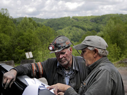 CLIMATE CHANGE: In this Wednesday, May 11, 2016 photo, Scott Tiller, left, a coal miner of 32 years, talks with Donnie Coleman, chief safety director and a coal miner of almost 40 years, about a new federal regulation they must adhere to as they work at an underground coal mine …