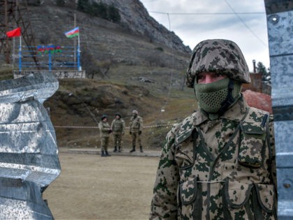 Azerbaijani soldiers patrol at a checkpoint on a road outside the town of Shusha on November 26, 2020, after six weeks of fighting between Armenia and Azerbaijan over the disputed Nagorno-Karabakh region. - A Moscow-brokered peace deal was announced on November 10 after Azerbaijan's military overwhelmed Armenian separatist forces and …