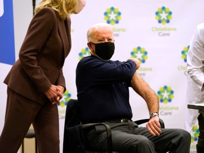 NEWARK, DE - DECEMBER 21: Jill Biden (L) looks on as President-elect Joe Biden (R) rolls up his sleeve to receive a COVID-19 vaccination at ChristianaCare Christiana Hospital on December 21, 2020 in Newark, Delaware. The rollout of the Moderna vaccine, the second approved for use in the United States, …