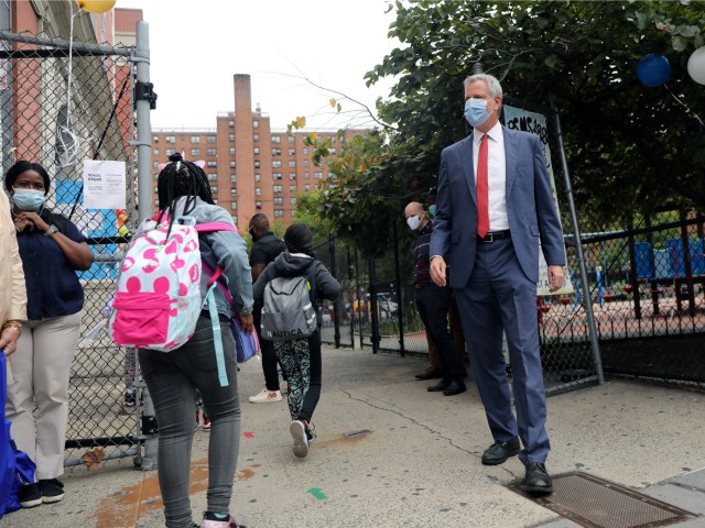 New York City Mayor Bill de Blasio stands at P.S. 188 as he welcomes elementary school students back to the city's public schools for in-person learning on September 29, 2020 in New York City. Middle and high schoolers will start on Oct. 1 while Pre-K students and students with disabilities could return to school starting on Sept. 21. On Sunday, the executive board of the union representing more than 6,400 of New York City's school leaders passed a unanimous vote of no confidence against Mayor Bill de Blasio and Schools Chancellor Richard Carranza for what they called a failure to lead New York City through the safe and successful reopening of its schools. (Photo by Spencer Platt/Getty Images)