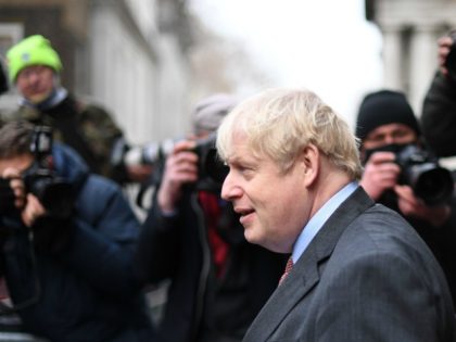 Britain's Prime Minister Boris Johnson returns to 10 Downing Street in London on December 8, 2020 after chairing the weekly cabinet meeting held at the nearby Foreign, Commonwealth and Development Office. - Britain on Tuesday hailed a turning point in the fight against the coronavirus pandemic, as it begins the …