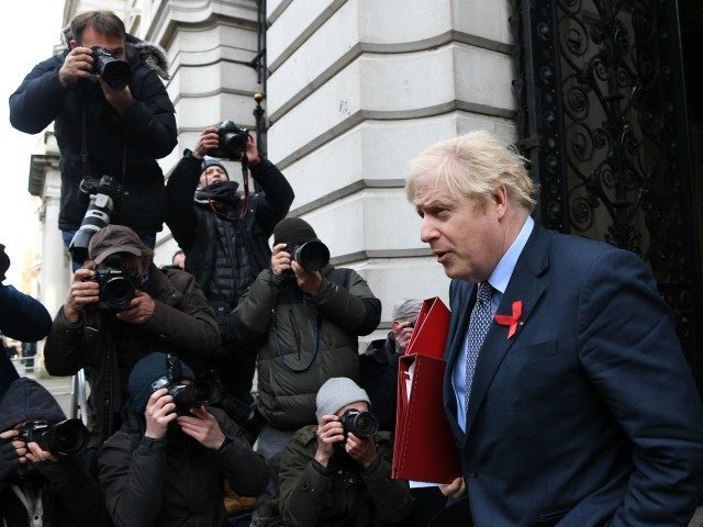 Britain's Prime Minister Boris Johnson returns to 10 Downing Street in London on December 1, 2020 after attending the weekly cabinet meeting held at the nearby Foreign, Commonwealth and Development Office. - UK lawmakers were set to vote on a new toughened system of tiered coronavirus restrictions on December 1 …