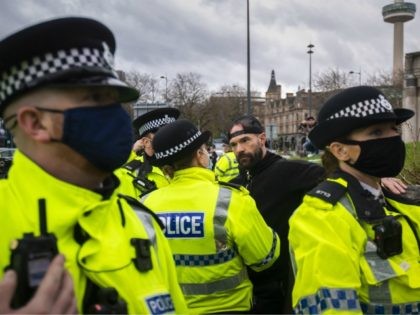 LIVERPOOL, ENGLAND - NOVEMBER 14: Paul Boys is detained and arrested by Police officers during an anti lockdown protest on November 14, 2020 in Liverpool, England. Throughout the Covid-19 pandemic, there have been recurring protests across England against lockdown restrictions and other rules meant to curb the spread of the …