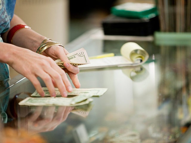 Shop keeper counting money in shop