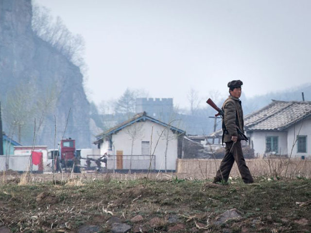 A North Korean soldier walks near the Yalu river near Sinuiju, opposite the Chinese border city of Dandong, on April 16, 2017. Dandong city is the main crossing point to North Korea, and every day hundreds of tourists embark on small boats for a cruise on the Yalu border river …
