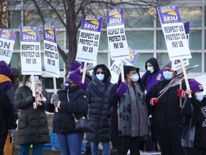 CHICAGO, ILLINOIS - DECEMBER 22: Healthcare workers with Cook County Health picket outside of Stroger Hospital as they stage a one-day strike on December 22, 2020 in Chicago, Illinois. Among other issues, the workers were demanding an additional $5-per-hour for those who work with COVID-19 patients, adequate PPE supplies for …