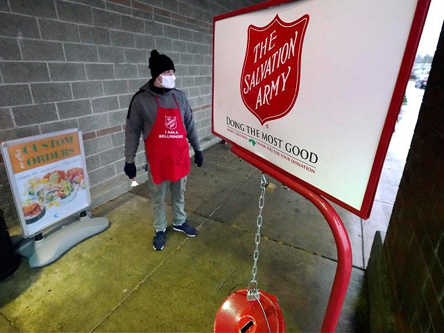 CORRECTS SPELLING OF DATELINE TO LYNDEN INSTEAD OF LINDEN - Salvation Army bell ringer Michael Cronin staffs the charity's red donation kettle in front of a grocery store, Tuesday, Dec. 8, 2020, in Lynden, Wash. Despite record amounts of charitable donations this year, nonprofits across the country are being suffocated …