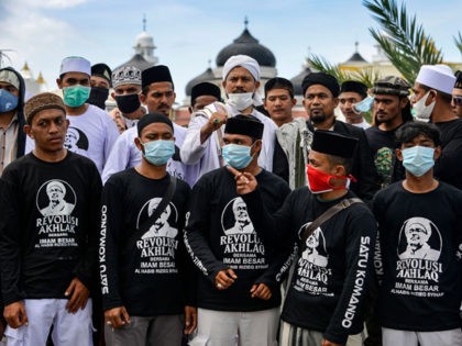 Supporters of Rizieq Shihab, leader of the Indonesian hardline organisation FPI (Front Pembela Islam or Islamic Defenders Front), gather in a show of support for the firebrand cleric in front of the Baiturrahman grand mosque in Banda Aceh on December 8, 2020, after at least six of his supporters were …