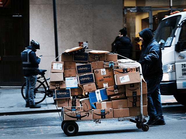 A man delivers packages along a street in midtown Manhattan on February 28, 2019 in New Yo