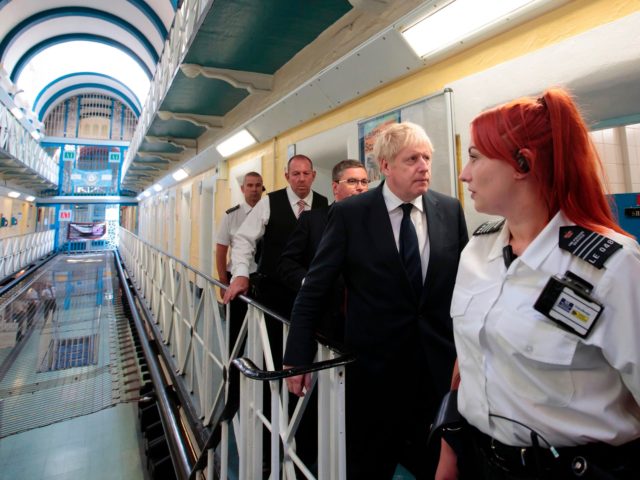 Britain's Prime Minister Boris Johnson (2R) talks with prison staff during a visit to HM Prison Leeds, a Category B men's prison in Leeds, northern England, on August 13, 2019. (Photo by Jon Super / POOL / AFP) (Photo credit should read JON SUPER/AFP via Getty Images)